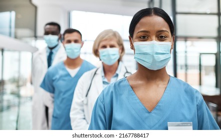 As medical professionals, we have such an important job to do. Portrait of a group of medical practitioners wearing face masks while standing together in a hospital. - Powered by Shutterstock