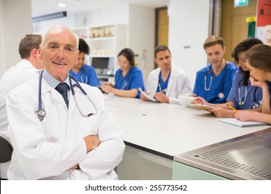 Medical professor smiling at the camera during class at the university