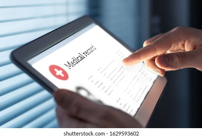 Medical record in electronic form. Digital EMR with patient health care information. Doctor using tablet in hospital or clinic. Personal data in mobile device. Online database for healthcare history.