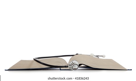 A Medical Reference Book With A Stethoscope On A White Background