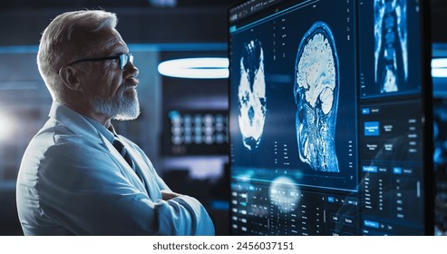 Medical Research Center: Close-Up Portrait Of Caucasian Male Neurologist, Neuroscientist, Neurosurgeon, Looks at TV Screen with Brain MRI Scan Images, Thinks about Sick Patient Treatment Method. - Powered by Shutterstock