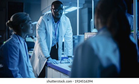 Medical Research Laboratory Meeting: Diverse Team Of Scientists Discuss Innovative Biotechnology Late In The Evening. Advanced Lab For Medicine, Vaccine Development. Dark Blue Shot