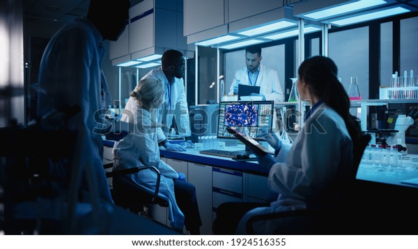 Medical Research Laboratory Meeting: Diverse Team of\
Scientists Use Digital Tablet Computer, Discuss Innovative\
Biotechnology. Advanced Lab for Medicine, Technology Development.\
Blue Evening Shot