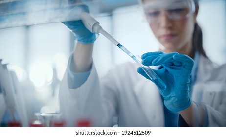 Medical Research Laboratory: Portrait of a Beautiful Female Scientist Using Micro Pipette for Analysis. Advanced Scientific Lab for Medicine, Biotechnology, Microbiology Development. Hands Close-up