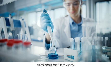 Medical Research Laboratory: Portrait Of A Beautiful Female Scientist In Goggles Using Micro Pipette For Test Analysis. Advanced Scientific Lab For Medicine, Biotechnology, Microbiology Development