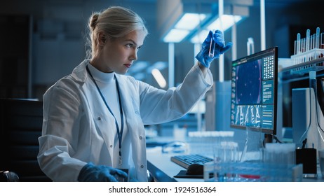 Medical Research Laboratory: Portrait of Female Scientist Working on Computer, Analysing Liquid Sample in a Labolatory Flask. Advanced Scientific Lab for Medicine, Biotechnology, Vaccine Development - Powered by Shutterstock