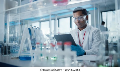 Medical Research Laboratory: Portrait of a Handsome Male Scientist Using Digital Tablet Computer to Analyse Data. Advanced Scientific Lab for Medicine, Biotechnology, Microbiology Development - Powered by Shutterstock