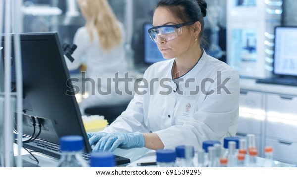 medical-research-scientist-typing-information-obtained-stock-photo