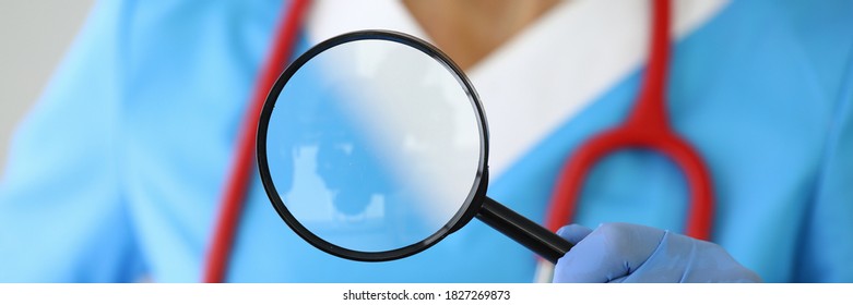 Medical Researcher Holds Magnifying Glass In His Hands. New Drug Development Concept