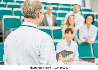 Medical School Lecturer Teach Doctors In Lecture Hall With Tablet