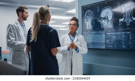 Medical Science Hospital Lab Meeting: Diverse Team Of Neurologists, Neuroscientists, Neurosurgeon Consult TV Screen Showing MRI Scan With Brain Images, Talk About Treatment Method, New Drugs Cure