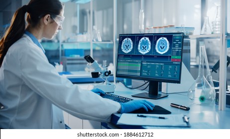 Medical Science Laboratory With Diverse Multi-Ethnic Team Of Biotechnology Scientists Developing Medicines, Neurobiologist Working On Computer With Display Showing Neuroimaging Of A Brain With Scans