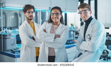 Medical Science Laboratory with Team of Three Young Successful Scientists. Beautiful Black Female, Handsome Latin and Caucasian Male Scientists Smile while Looking at Camera. Medium Portrait Shot - Powered by Shutterstock