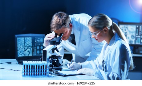 Medical Scientists Working In Lab. Doctor Teaching Interns To Make Blood Analyzing Research. Coronavirus, Biotechnology, Bacteriology, Virology And Health Care.