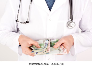 Medical services for a fee: doctor's hands counting EURO