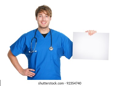 Medical Sign. Male Doctor / Nurse Showing And Holding Blank White Paper Sign Board With Copy Space For Text Or Message. Young Medical Professional Caucasian Man Isolated On White Background.