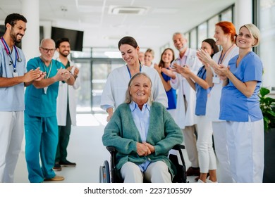 Medical staff clapping to senior patient who recovered from serious illness. - Powered by Shutterstock