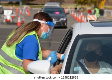 A Medical Staff Gives A Drive-thru Attendee An Influenza Vaccine During A Drive-thru Free Flu Shots To Members Of The Los Angeles Community At Cal State LA Parking Lot In Los Angeles, Nov. 20, 2020.