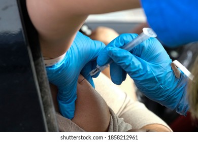 A Medical Staff Gives A Drive-thru Attendee An Influenza Vaccine During A Drive-thru Free Flu Shots To Members Of The Los Angeles Community At Cal State LA Parking Lot In Los Angeles, Nov. 20, 2020.