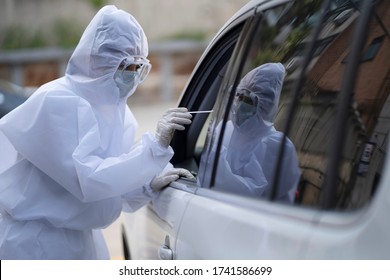 Medical staff in protective suit collecting sample for covid-19 at drive through
 - Powered by Shutterstock