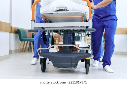 Medical Staff Pushing Patient On Medical Gurney At Emergency Department, Bottom View. Hospital Emergency And Healthcare Workers