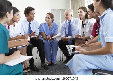 Medical Staff Seated In Circle At Case Meeting