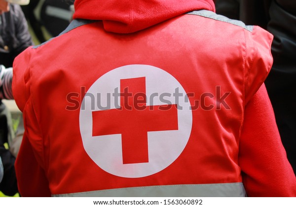 Medical staff in uniform with Red Cross  sing\
provides medical care at mass event.  Red Cross Volunteer helps\
people, emergency treatment, coronavirus epidemic, pandemic. Dnipro\
Ukraine. 9 05 2019