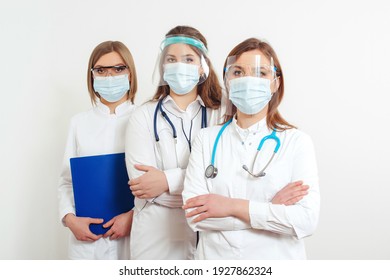 Medical Staff Wearing Face Shield And Medical Mask For Protect Coronavirus. Medicine, Vaccination And Healthcare. Hospital Staff During Quarantine. Group Of Doctors Ready To Fight Coronavirus.