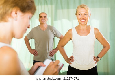 Medical staff with worksheet watching fitness class for elderly couple - Powered by Shutterstock