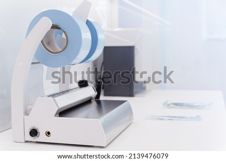 Medical sterilization packaging machine and roll pack for sterilized dental instruments.