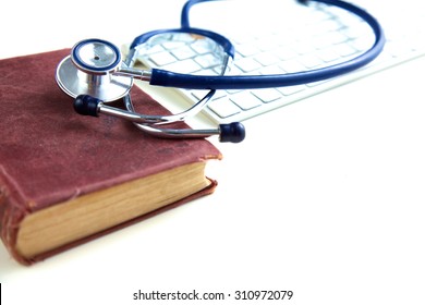 Medical Stethoscope With Books And Laptop On Table