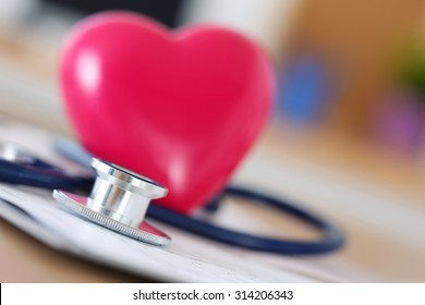 Medical Stethoscope Head And Red Toy Heart Lying On Cardiogram Chart Closeup. Medical Help, Prophylaxis, Disease Prevention Or Insurance Concept. Cardiology Care, Health, Protection And Prevention