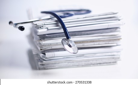 Medical Stethoscope On The Stack Of Paper