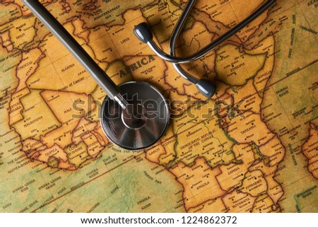 Medical stethoscope over Africa healthcheck. Fever vaccination concept tourism travel care diseases healthy, close-up. Stethoscope on map background with copy space, top view, selective focus. 