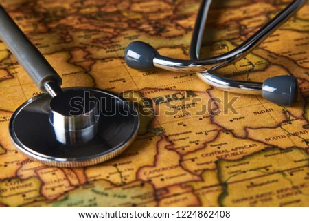 Medical stethoscope over Africa healthcheck. Fever vaccination concept tourism travel care diseases healthy, close-up. Stethoscope on map background with copy space, top view, selective focus. 