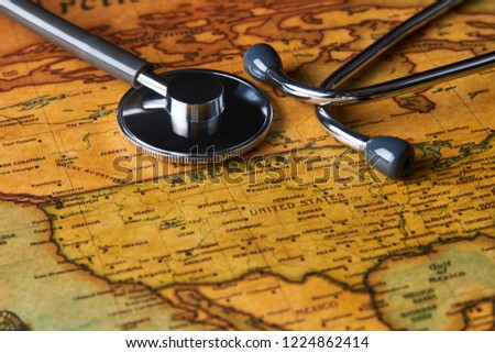 Medical stethoscope over America healthcheck. Medical concept tourism travel care diseases healthy, close-up. Stethoscope on map background with copy space, top view, selective focus. 