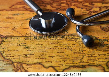 Medical stethoscope over America healthcheck. Medical concept tourism travel care diseases healthy, close-up. Stethoscope on map background with copy space, top view, selective focus. 