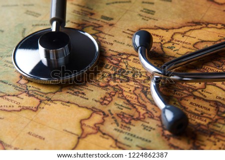 Medical stethoscope over Europe healthcheck. Medical concept tourism travel care diseases healthy, close-up. Stethoscope on map background with copy space, top view, selective focus. 
