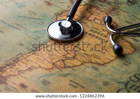 Medical stethoscope over South America healthcheck. Medical concept tourism travel care diseases healthy, close-up. Stethoscope on map background with copy space, top view, selective focus. 