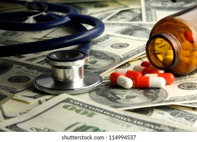  A medical stethoscope and pills on dollars - Powered by Shutterstock