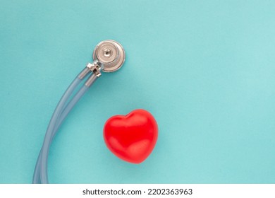 Medical Stethoscope And Red Heart On Blu Background.Heart Disease Awareness Prevention .Simply Minimal Design Health Care Concept. Top View. Close Up