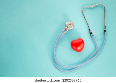 Medical Stethoscope And Red Heart On Blu Background.Heart Disease Awareness Prevention .Simply Minimal Design Health Care Concept. Top View. Close Up