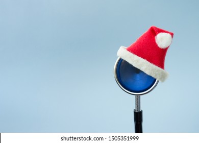 Medical stethoscope in a red Santa Claus hat on a light blue background. Christmas and New Year concept. Creative medical winter background, postcard. Copy space - Powered by Shutterstock