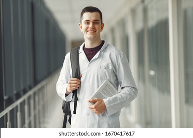 Medical student in with a backpack is standing in a modern clinic. - Shutterstock ID 1670417617