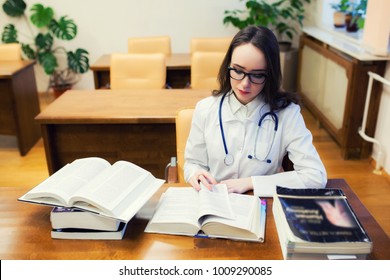 A Medical Student For Textbooks. The Study Of Surgery By A Beautiful Girl In The Library. Nurse