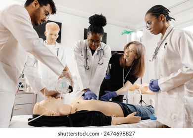 Medical students learn CPR and first aid techniques during a training session using a CPR dummy. - Powered by Shutterstock