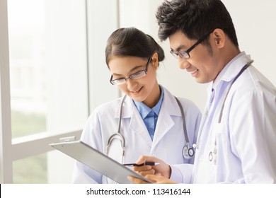 Medical students looking through a diagnosis form - Powered by Shutterstock