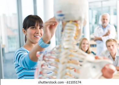 Medical Students And Professor With Skeleton In Classroom At University