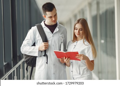 Medical students are reading a book in a hospital hall