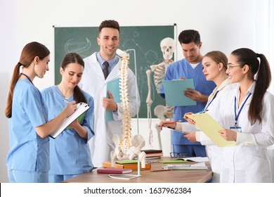 Medical Students Studying Human Spine Structure In Classroom